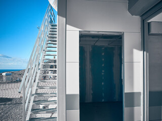 Metal stairway outside of mobile industrial building. Newly built two-storey prefabricated...