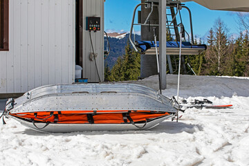 medical sled on a downhill slope for tramping downhill skiers and snowboarders. Active and safe...