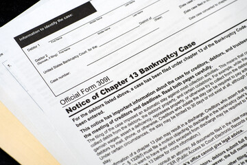 Close up of a chapter 13 bankruptcy notice on desk on a manila folder