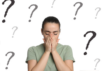 Amnesia. Confused young woman and question marks on white background
