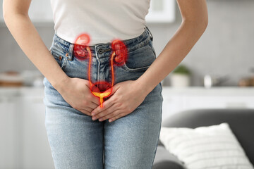 Woman suffering from cystitis at home, closeup. Illustration of urinary system