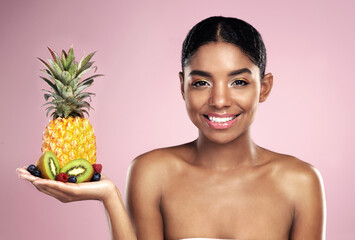 Black woman, studio portrait and fruit in hand for beauty with tropical food, makeup and diet with...