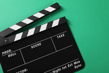 Clapperboard on green background, top view. Space for text