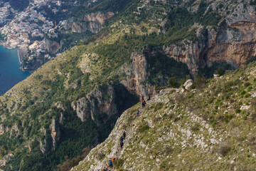 View at hiking trail Sentiero degli Dei or Path of the Gods with group of hikers along the Amalfi Coast, Province of Salerno, Campania, Italy