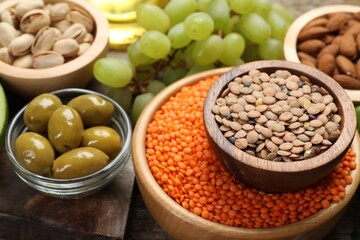 Different products high in natural fats on wooden table, closeup