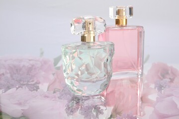 Luxury perfumes on spring floral decor, space for text