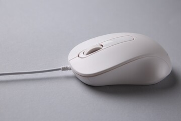 One wired mouse on grey background, closeup
