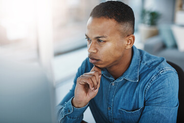 Thinking, serious and black man by computer in office, workspace or desk professional in creative...