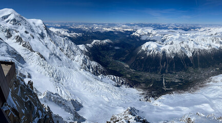Haute-Savoie, France, 04-25-2024: panoramic view of the Chamonix Valley seen from the top of L’Aiguille du Midi (Needle at midday), the highest spire (3.842 m) of the Aiguilles de Chamonix, Mont Blanc