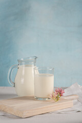 Cow's milk with a glass glass on a light background