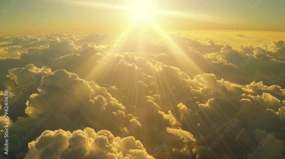 Poster the sun is brightly shining down from above, casting light over a layer of fluffy white clouds in th
