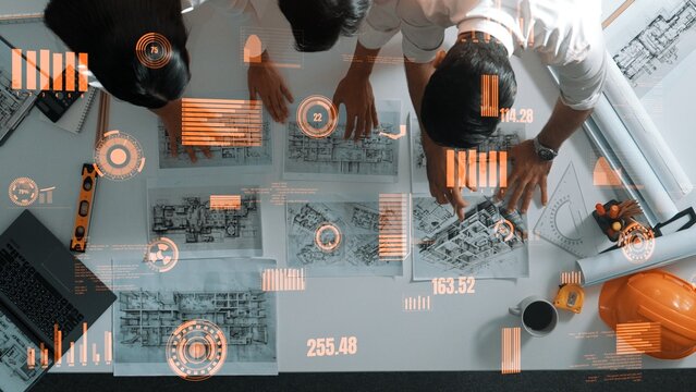 Top down view of skilled architect engineer team working together to design house. Aerial view of project manager pointing and explain construction with financial chart and statistic. Alimentation.