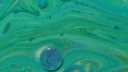 Various colors of paint mixing with mineral oil and dish soap