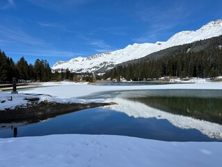 A typical winter idyll on the frozen and snow-covered alpine lake Heidsee (Igl Lai) in the Swiss winter resorts of Valbella and Lenzerheide - Canton of Grisons, Switzerland (Schweiz)