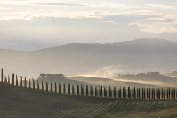 early morning with beautiful sunrise over the Val d'Orcia, countryside in Tuscany.