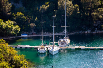 Sailing boats anchored in the Krka river estuary in the close porximity of the town of Skradin,...