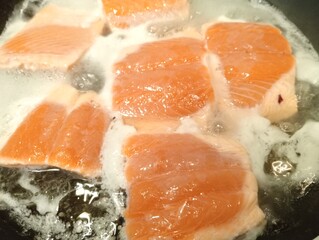salmon steak cooking in a pan