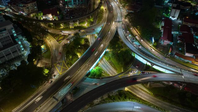 night time illumination flight over kuala lumpur city traffic road junction aerial panorama 4k timelapse malaysia