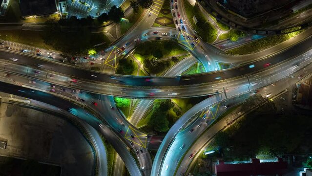 night time illumination flight over kuala lumpur city traffic interchange circle road aerial topdown panorama 4k timelapse malaysia