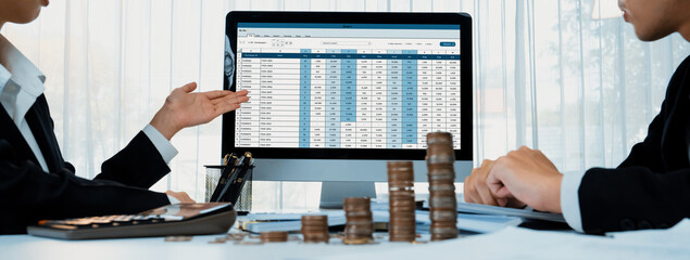 Corporate accountant use accounting software on laptop to calculate and maximize tax refunds and...