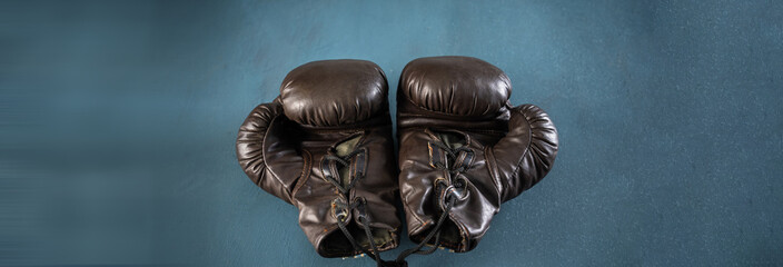 black boxing gloves, studio settings, sports concept stock photo, blue, gray background