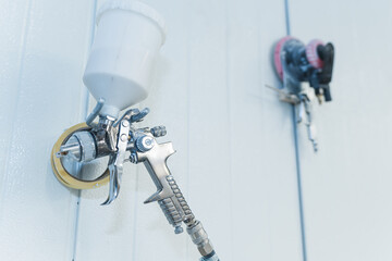 closeup shot of a spray gun hanging on wall, carpenter service. High quality photo