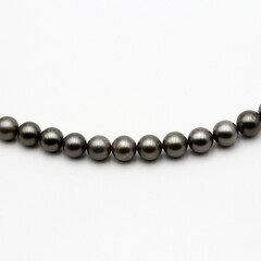 Expensive and luxurious Tahiti black pearls in a stylish necklace on white background, ready to be...
