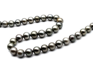 Expensive and luxurious Tahiti black pearls in a stylish necklace on white background, ready to be made into earrings, pendants, bracelets or a choker and sold in jewelry store.