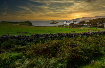 House on the Scottish coast on the isle of skye The background of the sea by the evening sea, with natural beauty. Sunset landscape scene - obrazy, fototapety, plakaty