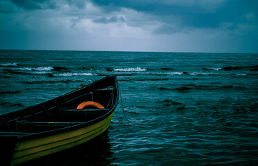 Braving the Storm: A Lone Boat Sails Through Dramatic Seas

