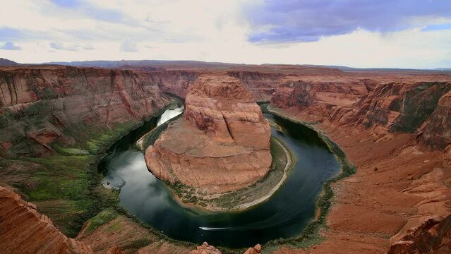 A small recreational pleasure boat zooms accross the Colorado River river at Horseshoe Bend section of the Colorado River in Arizona