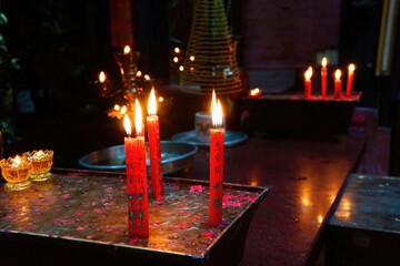 Votive candles and incense, with Buddha