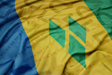 waving colorful national flag of saint vincent and the grenadines on a euro money banknotes background. finance concept. - obrazy, fototapety, plakaty