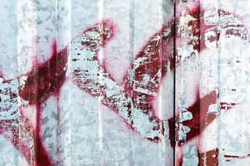 Rusted metal sheet with red graffiti, peeled paint, urban decay, industrial charm