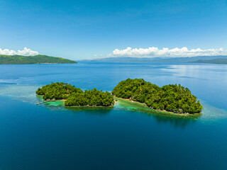 Islands with beach resort in tropical landscape. Bangkay Island. Mindanao, Philippines. Summer and...