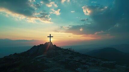 Explore the symbolic significance of a cross silhouetted against the dawn sky on a mountain peak