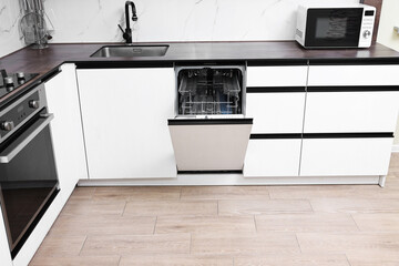 Built-in dishwasher with open door in kitchen