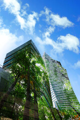 Fototapeta na wymiar Double exposure of green trees and buildings in city