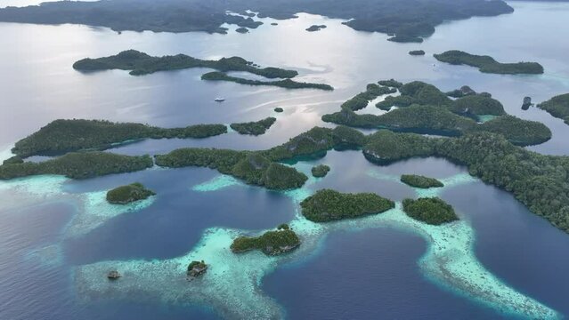 Early morning light illuminates the beautiful limestone islands of Pef in Raja Ampat, Indonesia. This remote, tropical region is known to harbor the world's greatest marine biodiversity.