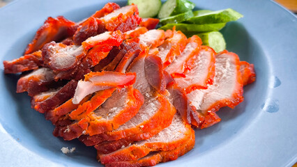 Red pork on rice in a blue plate