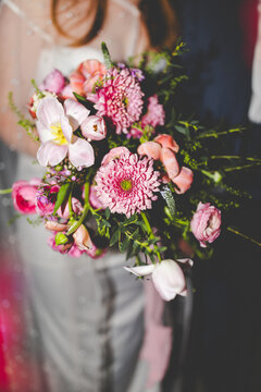 Close Up Night Portrait of Spring Wedding Bouquet with Tones of Green and Pink, Y2K Film Aesthetic Wedding Photo Taken at Night with Creative Light Leaks, Trendy Wedding Photo of Bridal Bouquet