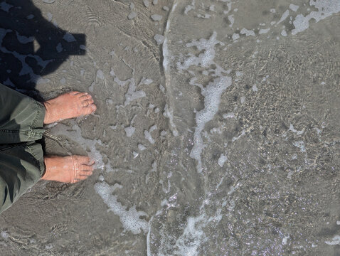 feet in the waves