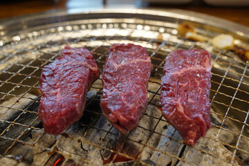 Thick beef grilled directly on a charcoal grill