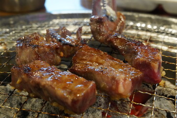 Thick beef grilled directly on a charcoal grill