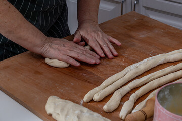 Women's hands knead the dough for dumplings
