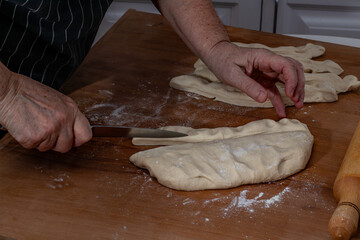 Woman kneading dough in kitchen