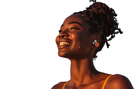 A young man with a genuine smile, wearing stylish over-ear headphones, isolated on a white background