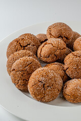 Warm Homemade Gingersnap Cookies on a light background in a plate