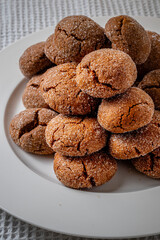 Warm Homemade Gingersnap Cookies on a light background in a plate