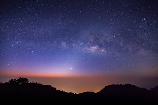 landscape silhouette tree on high moutain before sunrise with milky way galaxy
